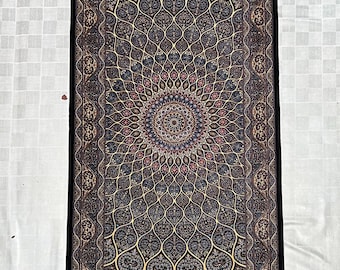 May include: An intricately patterned rug with a central medallion design. The rug has a dark background with gold, blue, and red patterns. The border is a darker shade, and one end has a fringe. The rug is likely made of wool or silk, and is suitable for a hallway.