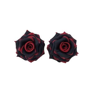May include: A pair of black and red rose earrings. The roses are made of polymer clay and have a realistic look.