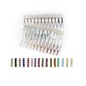 May include: Two silver hair combs with rows of clear rhinestones. The combs are stacked on top of each other.