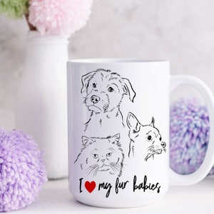 May include: White ceramic mug with a black line drawing of a dog, a cat, and a chihuahua. The mug has the text "I love my fur babies" with a red heart.