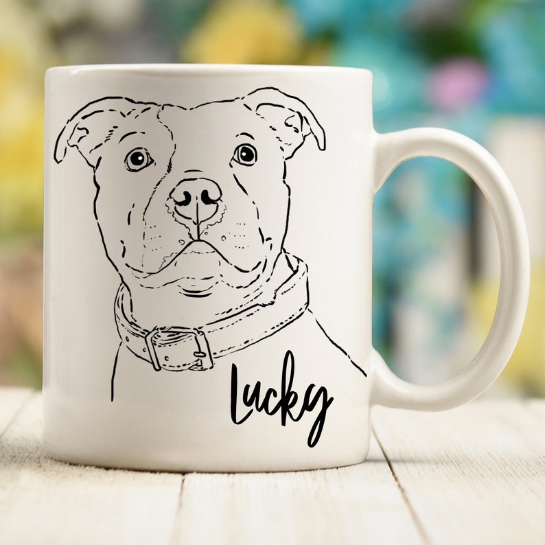 May include: White ceramic mug with a black line drawing of a pit bull terrier wearing a collar. The dog's name "Lucky" is written in cursive below the image.