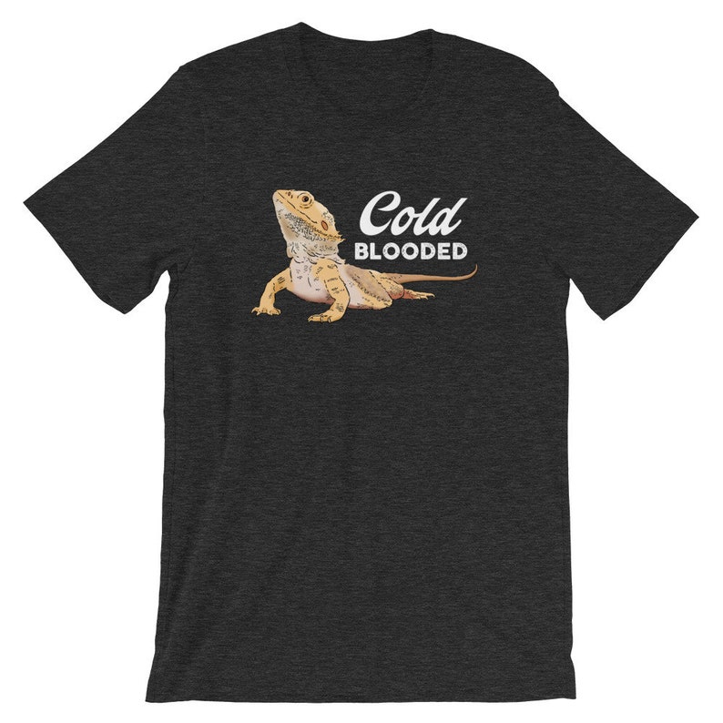 May include: A dark heather grey t-shirt with a cartoon bearded dragon and the text "Cold Blooded".
