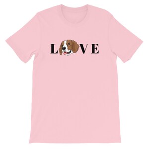 May include: Pink t-shirt with a black graphic of a beagle dog and the word "LOVE" on it.