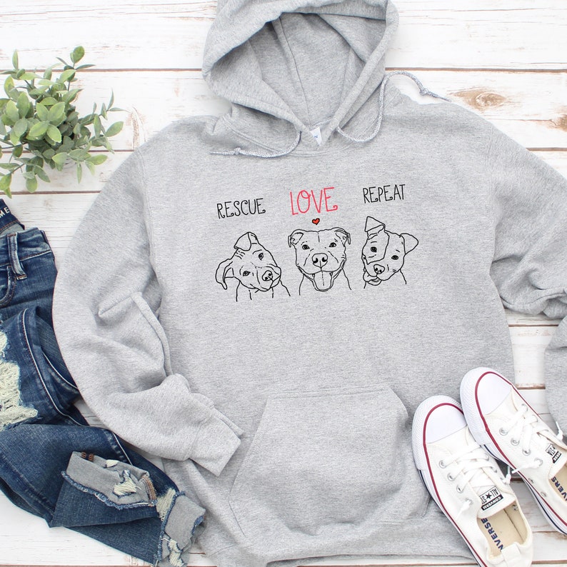 May include: Gray hooded sweatshirt with a graphic of three pit bull dogs and the text "Rescue Love Repeat".