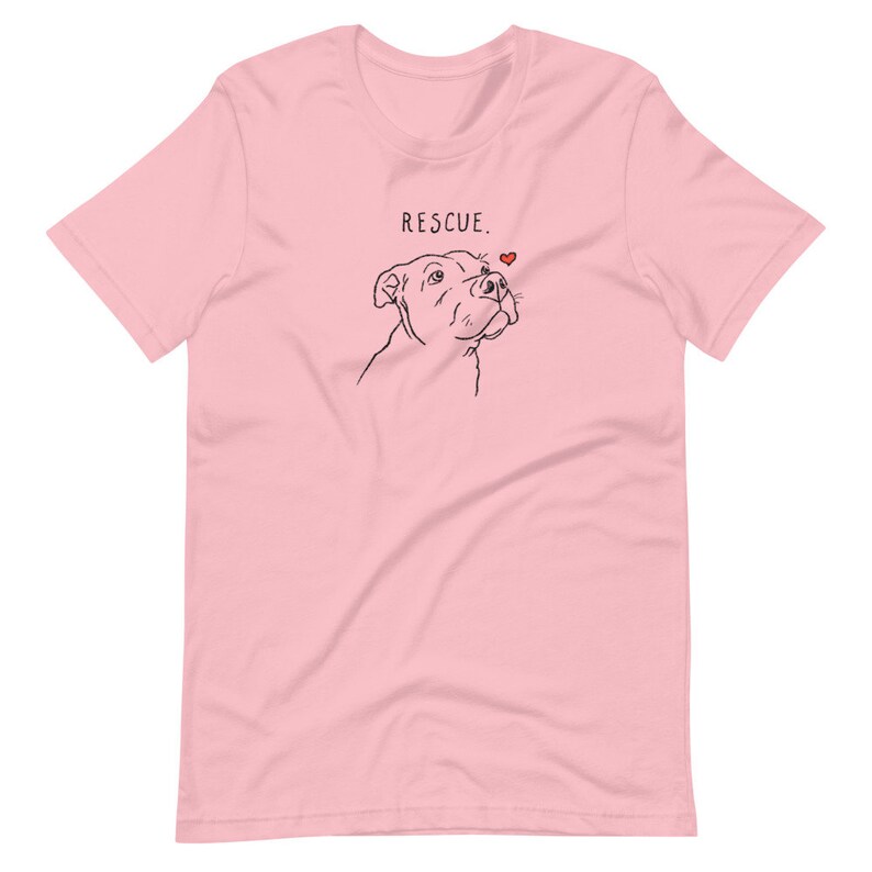 May include: Pink short-sleeved t-shirt with a black line drawing of a dog's head and the text "RESCUE." with a small red heart above the dog's head.