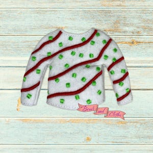 May include: White long-sleeved sweater with red diagonal stripes and green square accents. The sweater has a rounded neckline and is decorated with a red and pink ribbon that says "Bow's and Clothes".