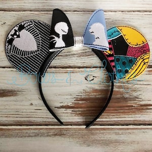 May include: Black and white mouse ears with a black and white bow. The ears feature a black and white striped pattern with a white silhouette of Jack Skellington and Sally from the Nightmare Before Christmas. The other ear features a patchwork pattern with various colors and textures.