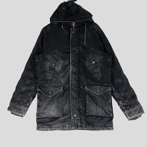May include: A black denim jacket with a hood and a zipper closure. The jacket has multiple pockets and a drawstring hood.