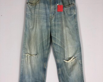 Vintage Levi's 569 Jeans: 90s Light Blue Stone Washed Ripped Denim