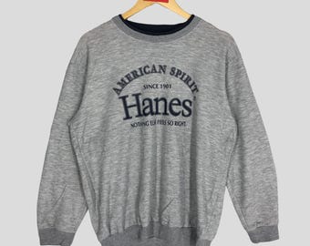 Sudadera Hanes vintage: Estampado American Spirit, cuello redondo gris (talla M)