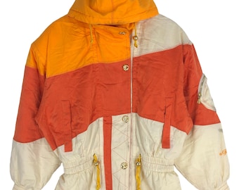 May include: A vintage ski jacket with a color block design in orange, red, and white. The jacket has a hood and a zipper closure. It features a drawstring waist and gold-toned buttons.
