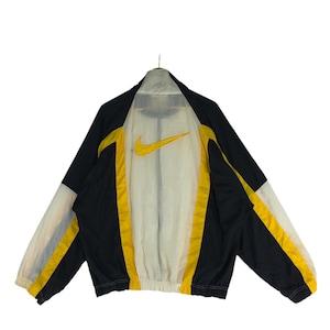 May include: A black and yellow windbreaker jacket with a white mesh lining and a Nike logo on the back.