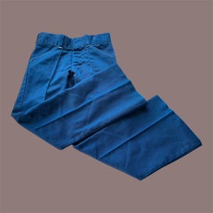 May include: Dark blue pants with a classic design. The pants feature a button and zipper closure, front pockets, and a tailored fit. The pants are made of a durable fabric and are suitable for various occasions.