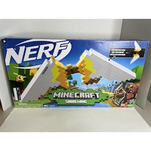 May include: A Nerf Minecraft Sabrewing motorized bow toy in its original rectangular cardboard packaging. The box features a large white and yellow pixelated bow graphic, the Minecraft logo, and a small illustration of a bee and a character.