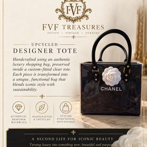 May include: A black tote bag encased in a clear protective shell, featuring the white Chanel logo and a white camellia flower accent. The bag has two black handles with gold-tone hardware. Text on the image includes FVF TREASURES and UPCYCLED DESIGNER TOTE.