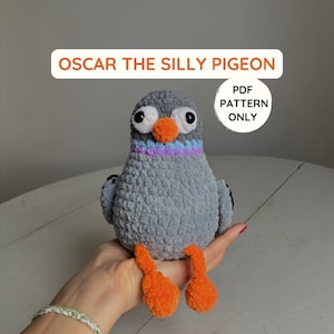 May include: Crochet pattern for a gray and orange silly pigeon amigurumi toy. The pattern is available as a PDF download. The text "Oscar the Silly Pigeon" and "PDF Pattern Only" is visible in the image.