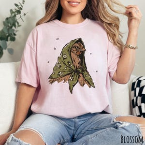 Blossom Comfort Colors unisex t-shirt featuring an illustrated hen wearing a green floral headscarf.