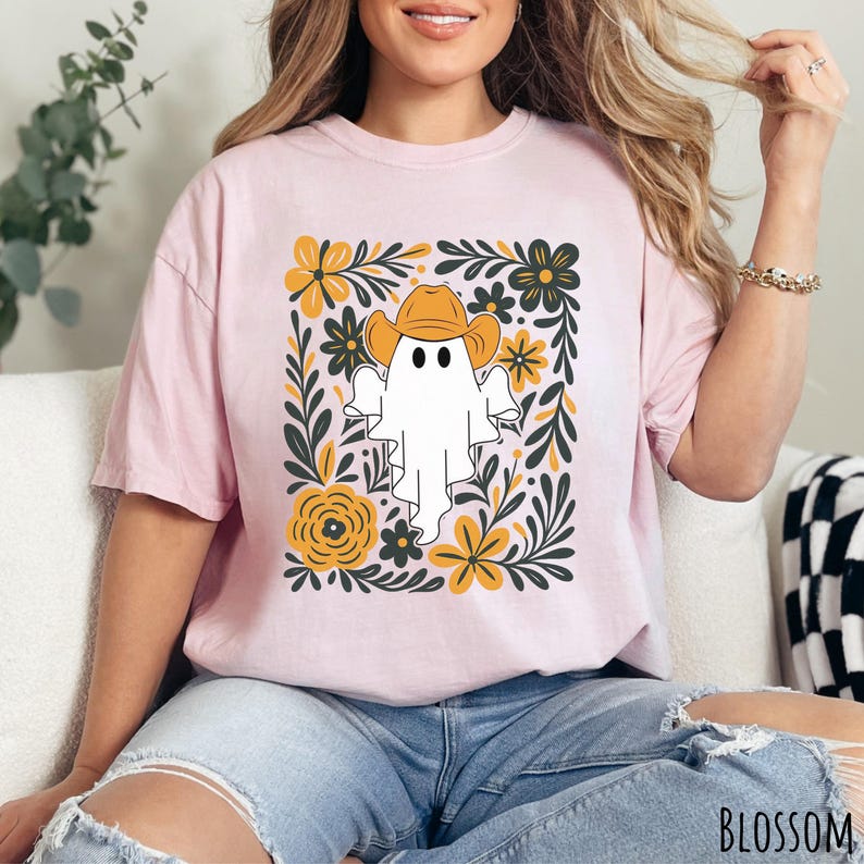 Blossom Comfort Colors t-shirt featuring a cute ghost wearing a cowboy hat, surrounded by yellow and green floral designs—perfect for fall, Halloween, and western style lovers.
