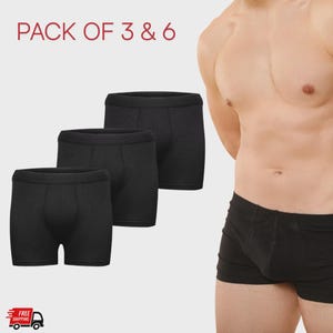 May include: Three pairs of black boxer shorts are displayed. The text "PACK OF 3 & 6" is at the top of the image. The shorts are made of a soft material. The image also includes a free shipping icon.