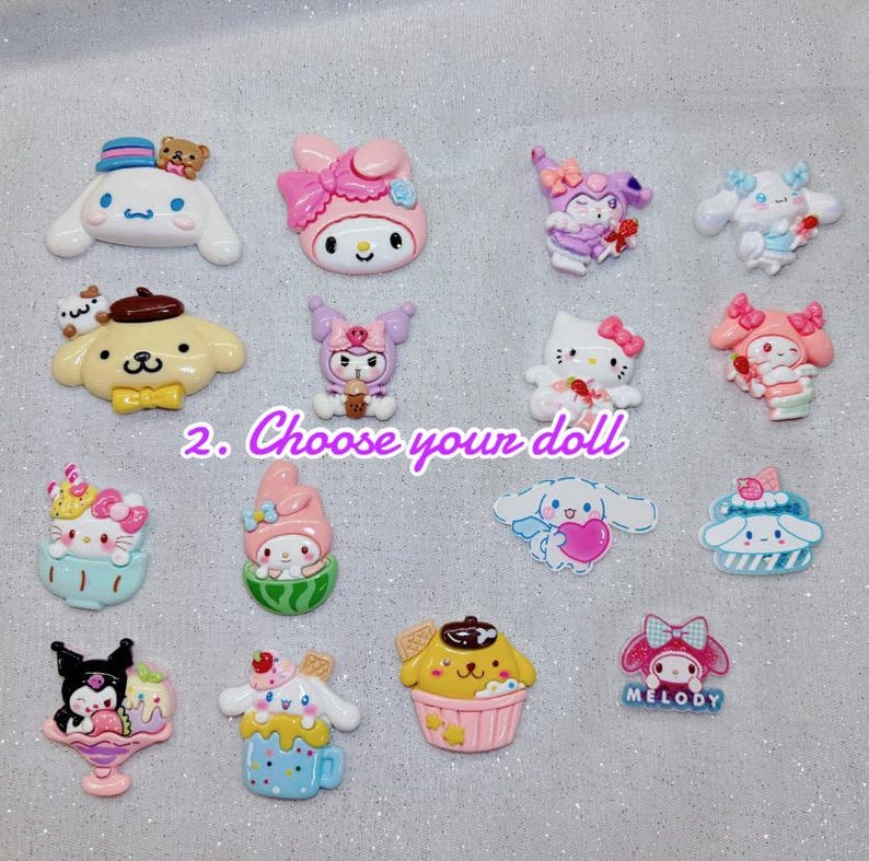 May include: A collection of colorful, cartoon character-themed resin charms. The charms feature various characters in pastel colors, including a white dog with a blue hat, a pink cat with a bow, and a yellow dog in a cupcake. The text "2. Choose your doll" is also present.