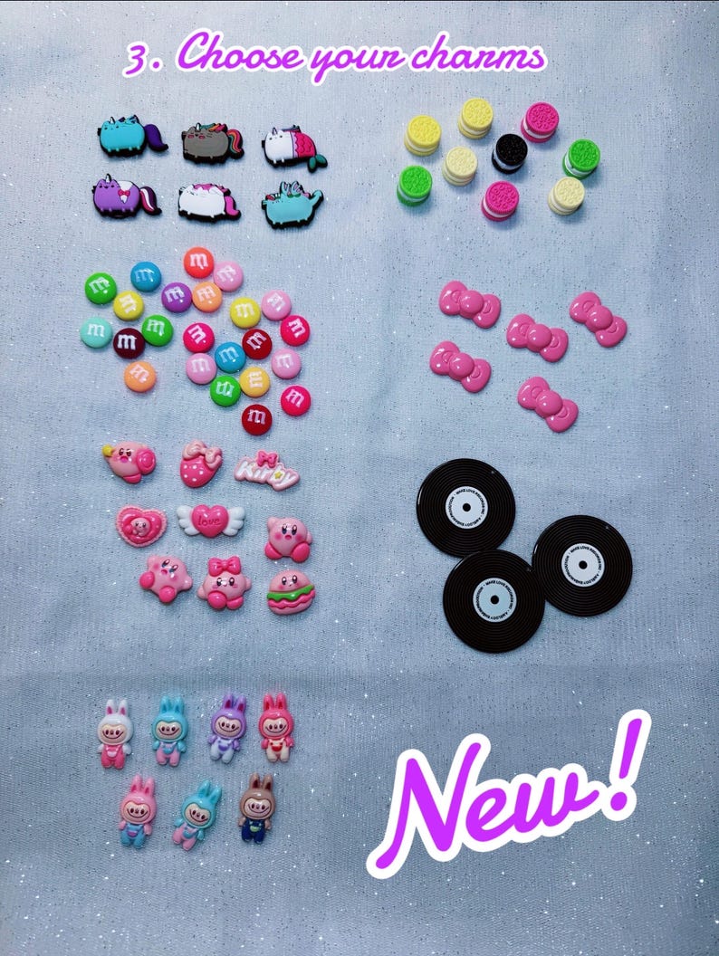 May include: A collection of colorful charms, including cartoon characters, candies, bows, and vinyl records. The image includes the text "3. Choose your charms" and "New!" on a light blue background.