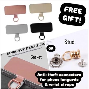 May include: Four different phone strap connectors made of stainless steel. The connectors are silver, black, gold, and rose gold. The connectors are designed to be used with phone lanyards and wrist straps. The image also shows a gold stud connector with a silver gasket. The text "FREE GIFT!" is in a white circle with a black outline. The text "Stud" is in black text. The text "OR" is in black text. The text "STAINLESS STEEL MATERIAL" is in black text. The text "It does not affect the charging, plug and charge more secure" is in black text. The text "Gasket" is in black text. The text "Anti-theft connectors for phone lanyards & wrist straps" is in black text.