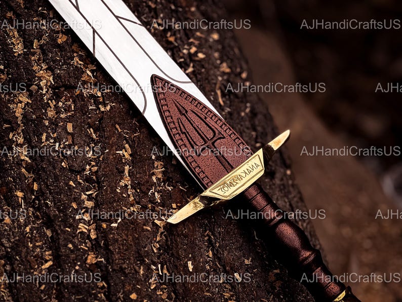 May include: A decorative sword with a white blade and a brown handle. The hilt features a brown emblem with a trident design and gold accents. The text "ZOMYAXAIMA" is visible on the hilt.