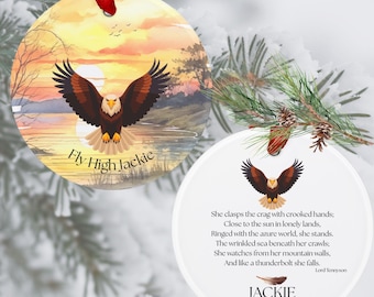 May include: Two round ceramic ornaments with red ribbons. One features a bald eagle flying over a sunset landscape with the text Fly High Jackie. The other displays a smaller eagle, a poem by Lord Tennyson, the name Jackie, and the years 2012-2026.