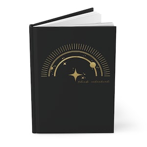 May include: A black journal with a gold celestial design and the text "think celestial".
