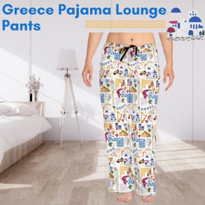 May include: White pyjama pants with a colourful pattern of Greek landmarks, including the Acropolis, the Parthenon, and the Greek flag. The text "Greece" is repeated throughout the pattern.