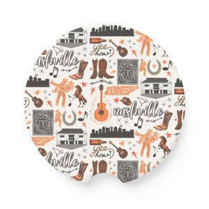 May include: A white round coaster with a repeating pattern of Nashville-themed illustrations. The illustrations include a guitar, a horseshoe, a building, a star, a boot, a music note, and the words "yee haw" and "Nashville".