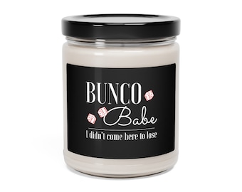May include: A white candle in a glass jar with a black label that says "BUNC0 Babe I didn't come here to lose". The label also has a red and white dice graphic.