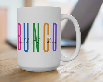 May include: White ceramic mug with the word "BUNGO" in rainbow colors and the text "roll the dice" in black script.
