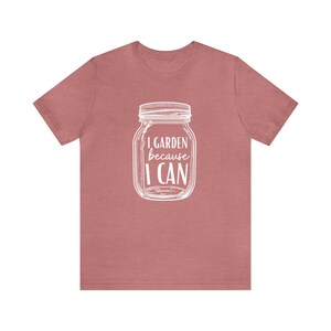 May include: A heather pink t-shirt with a white graphic of a mason jar with the text "I GARDEN because I CAN".