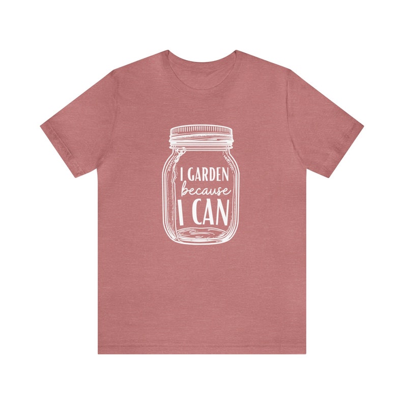 May include: A heather pink t-shirt with a white graphic of a mason jar with the text "I GARDEN because I CAN".