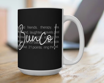 May include: White ceramic mug with a black background and the word "Bunco" in a cursive font. The mug also features white text with phrases like "good friends, therapy, wine" and "21 points, ring the bell."