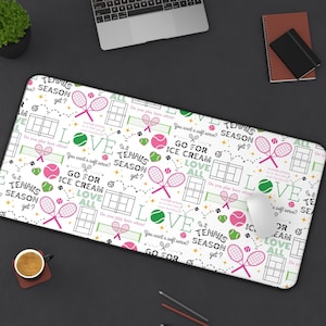 May include: White mouse pad with a repeating pattern of tennis rackets, tennis balls, and the text "Is it tennis season yet?" and "Go for ice cream, love all".
