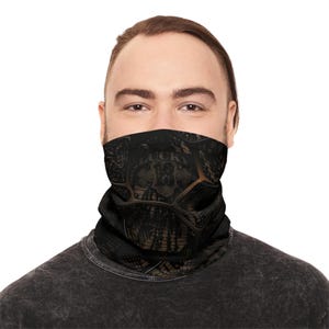 May include: Black and brown face covering with a decorative design and the word "LUCKY" visible. The face covering is worn around the neck and covers the lower face. The design includes a skull and the number 13.