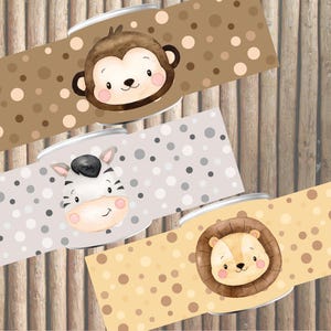 Może przedstawiać: Trzy brązowe, szare i żółte etykiety z białymi kropkami i twarzami zwierząt. Etykiety przedstawiają małpę, zebrę i lwa.