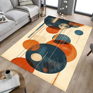 May include: A rectangular rug with an abstract design. It features large overlapping circles in orange, teal, and cream, with thin black and brown lines. The rug is placed on a wooden floor.