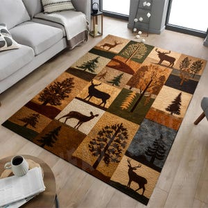 May include: A rectangular area rug featuring a patchwork design of earth-toned squares. Each square displays a silhouette of a deer or a pine tree in shades of brown, tan, green, and dark gray. The rug has a textured surface and a repeating pattern.
