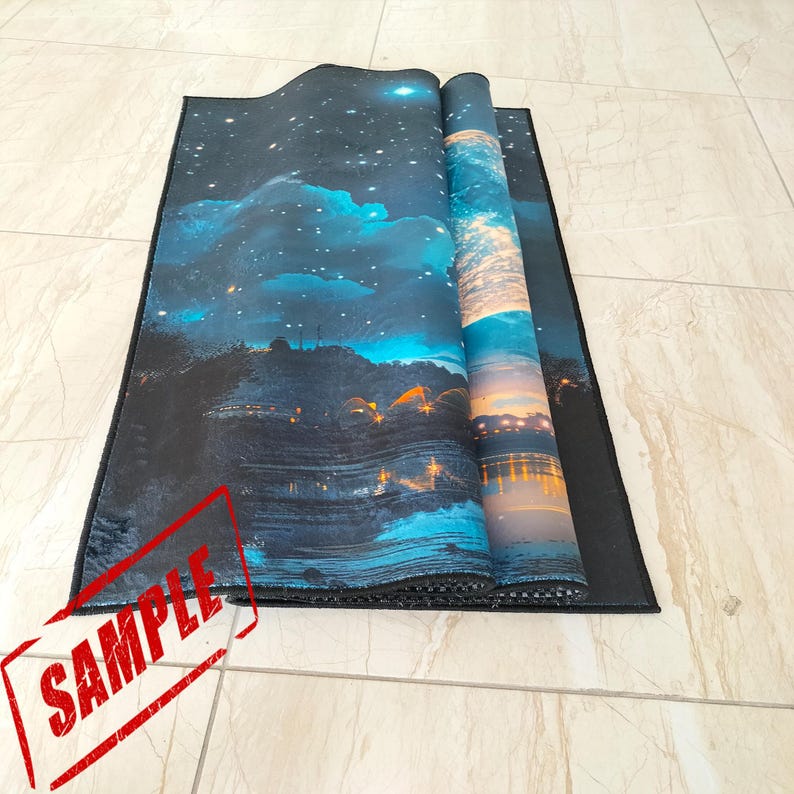 Pode incluir: Um tapete retangular enrolado com um design de c&eacute;u noturno e paisagem. A obra de arte apresenta um c&eacute;u estrelado, nuvens e um corpo de &aacute;gua com luzes. O tapete tem uma borda preta e um carimbo "SAMPLE".