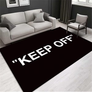 Black "Keep Off" Rug: Modern Graphic Floor Covering