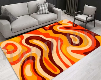 May include: Abstract area rug with a swirling pattern in shades of orange, yellow, brown, and cream.