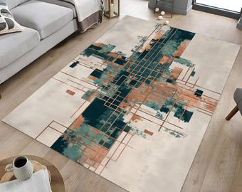 May include: A rectangular area rug with an abstract design. The rug features a cream-colored background with a geometric pattern in teal, copper, and light blue. The design includes intersecting lines and brushstroke-like shapes.