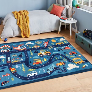 May include: A blue and white play rug with a road and traffic theme. The rug features cars, trucks, helicopters, and airplanes. The text "Get On The Road" is printed on the rug.