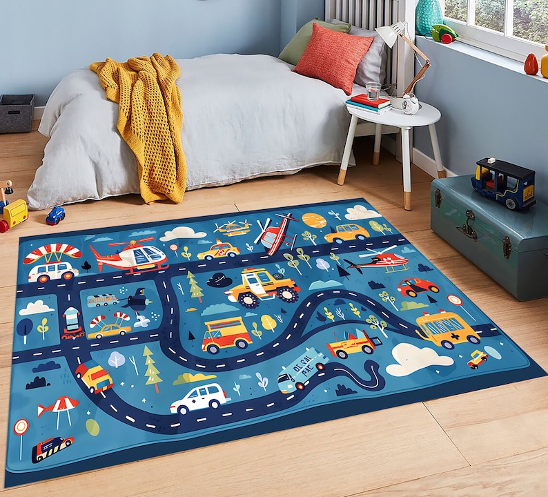 May include: A blue and white play rug with a road and traffic theme. The rug features cars, trucks, helicopters, and airplanes. The text "Get On The Road" is printed on the rug.