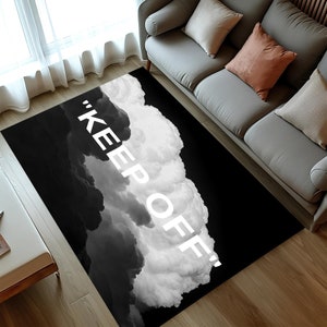 Può includere: Tappeto da area nero e bianco con un design a nuvole e il testo "KEEP OFF!" stampato in bianco.
