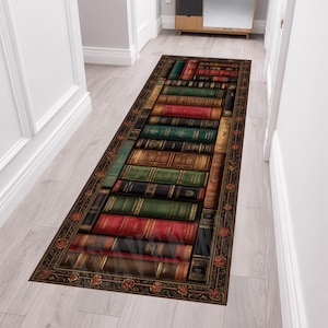 May include: A rectangular runner rug featuring a printed design of stacked vintage books in shades of red, green, brown, and black. The rug is framed by a decorative border with repeating floral motifs, creating a library-inspired aesthetic.