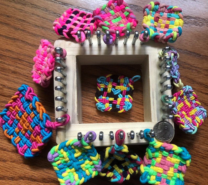 May include: A wooden loom with colorful rubber band bracelets in various patterns and colors. The loom has metal pegs and is used to create bracelets.